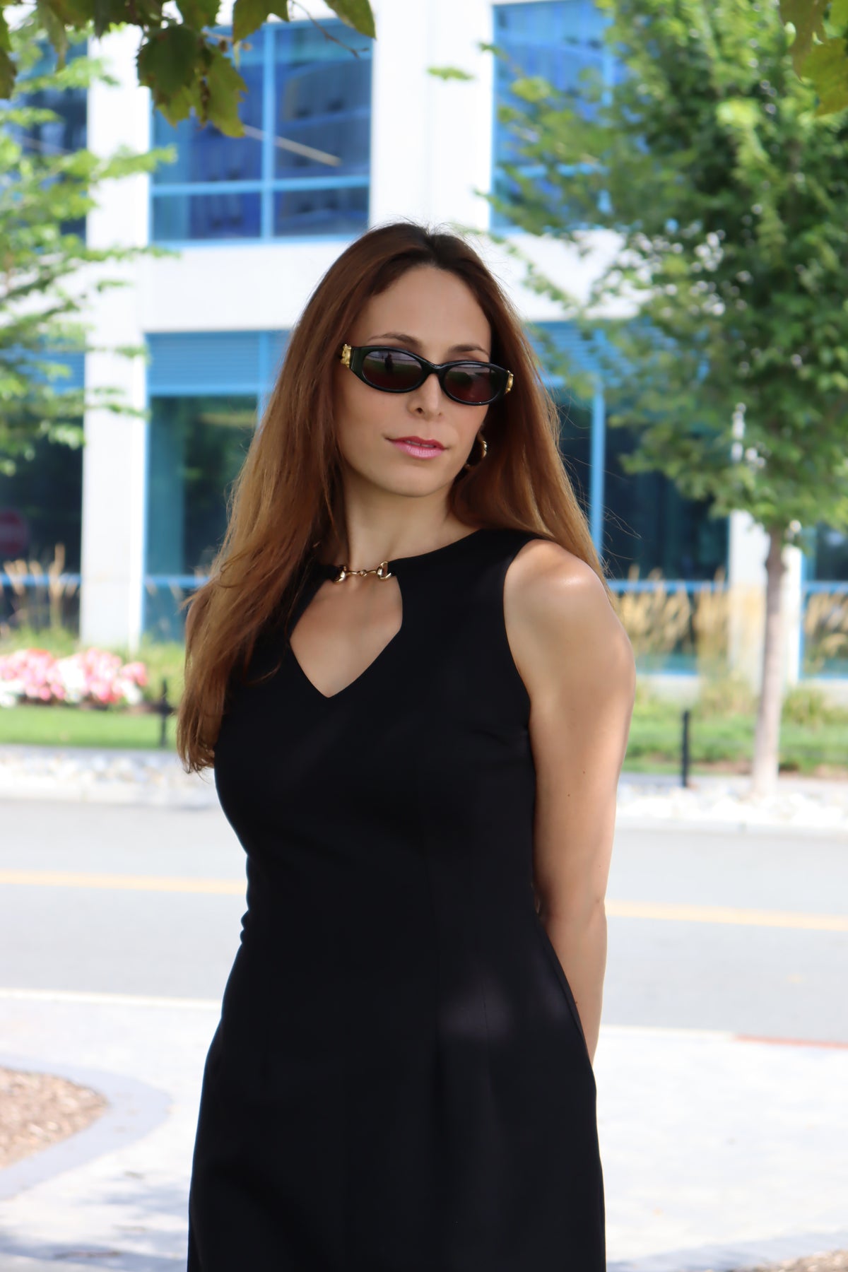 Model standing in the shade, sporting our Black Snaffle Bit Key Hole dress, wearing sunglasses
