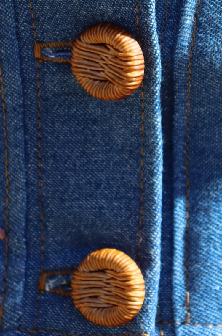 Close up of buttons of Flower Child floral embroidered denim Crop Top.