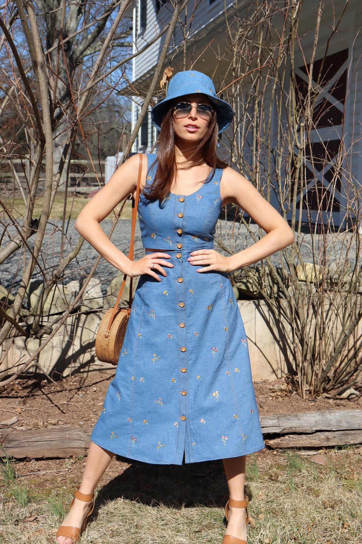 Model with hands on hips wearing Flower Child floral embroidered denim Crop Top.
