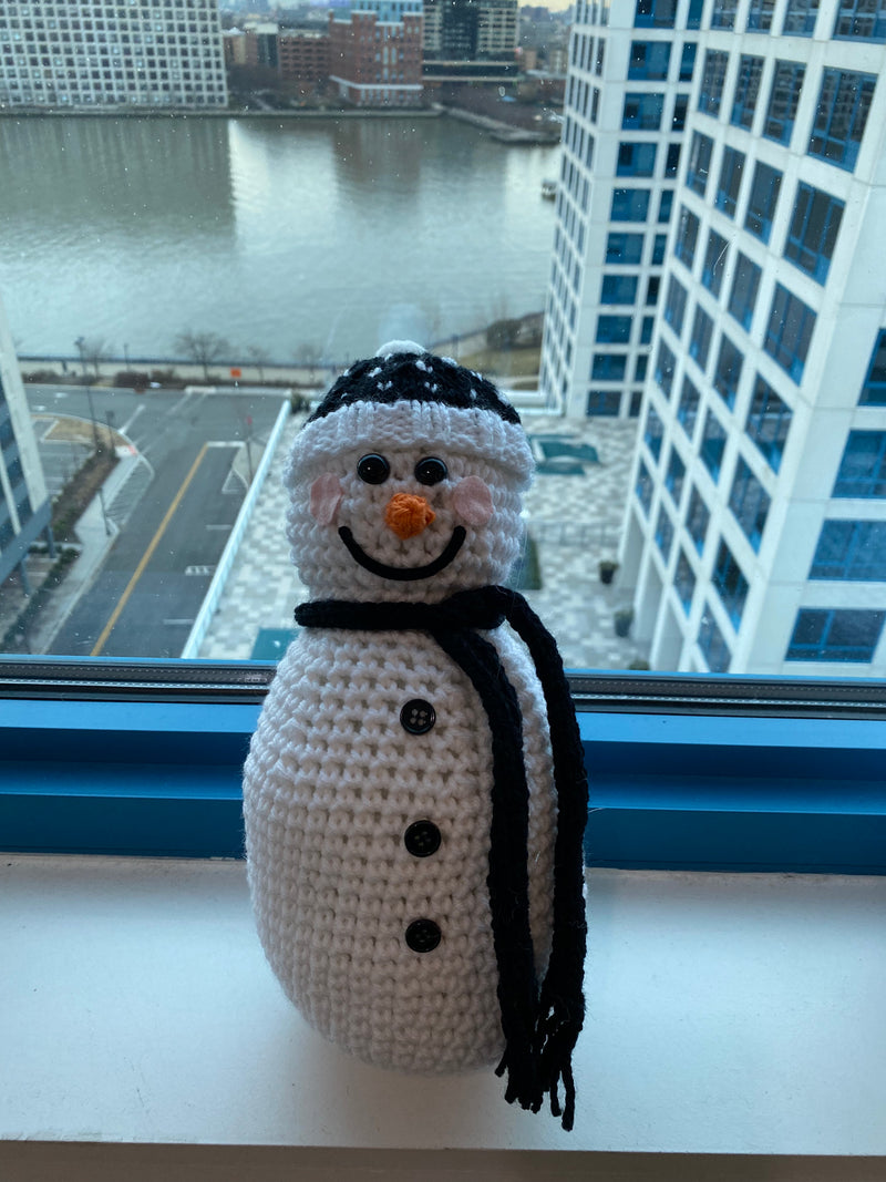 Our crocheted snowman with black scarf and beanie with hearts