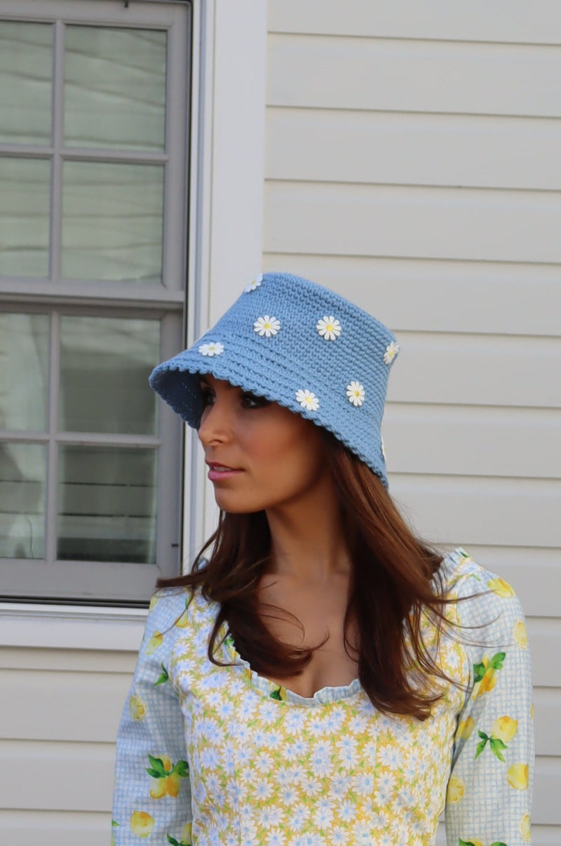 Side view of model wearing Hand Crocheted Bucket Hat with Daisies.