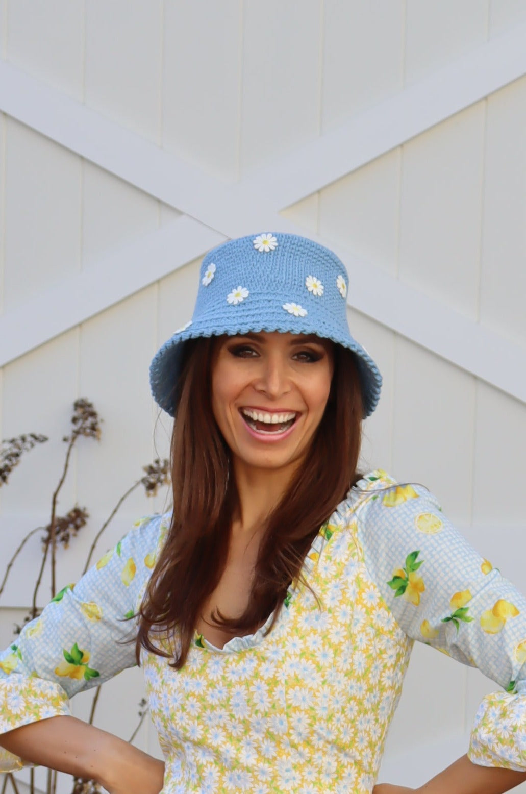 Model smiling with hands on hips wearing Hand Crocheted Bucket Hat with Daisies.