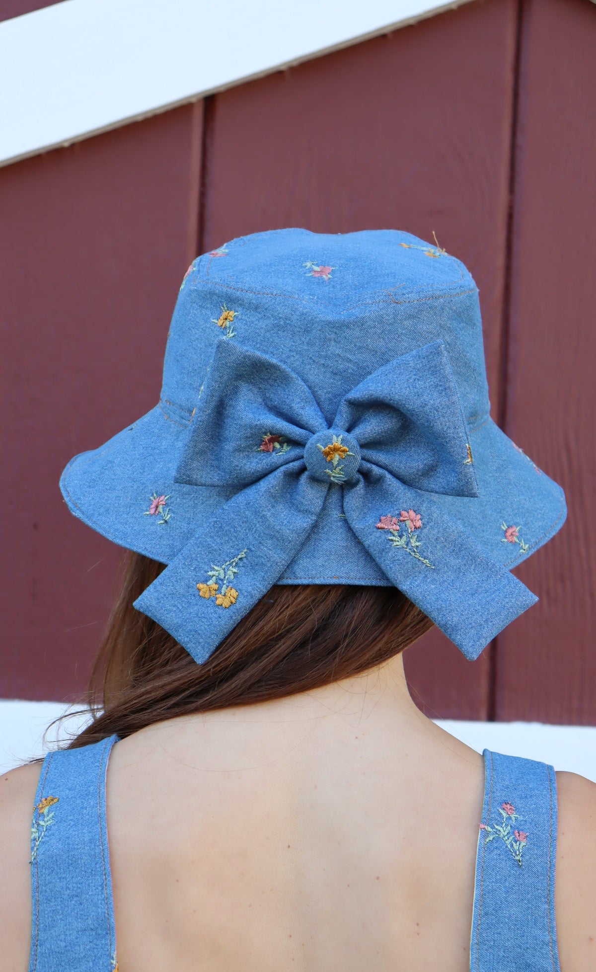 Back view of model wearing Floral Denim Bucket Hat with Bow.