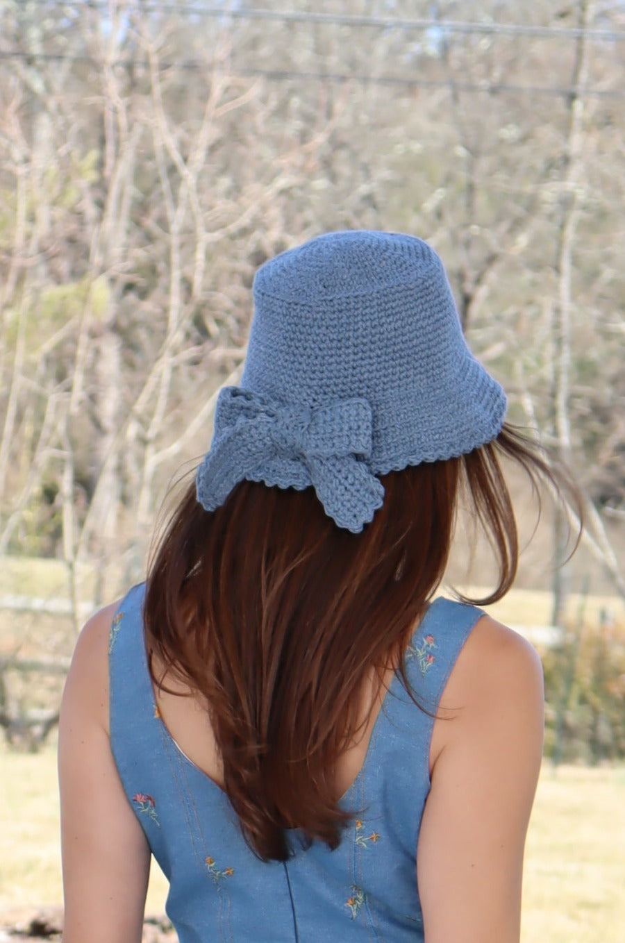 Model showing back view of Hand Crocheted Bucket Hat with Bow.