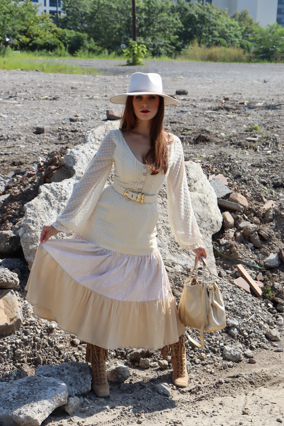 Model wearing dress with three different fabrics, Swiss Dot, Calico and Gauze midi dress, a belt, hat and purse.